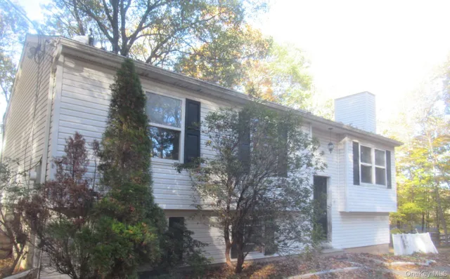 a front view of a house with trees