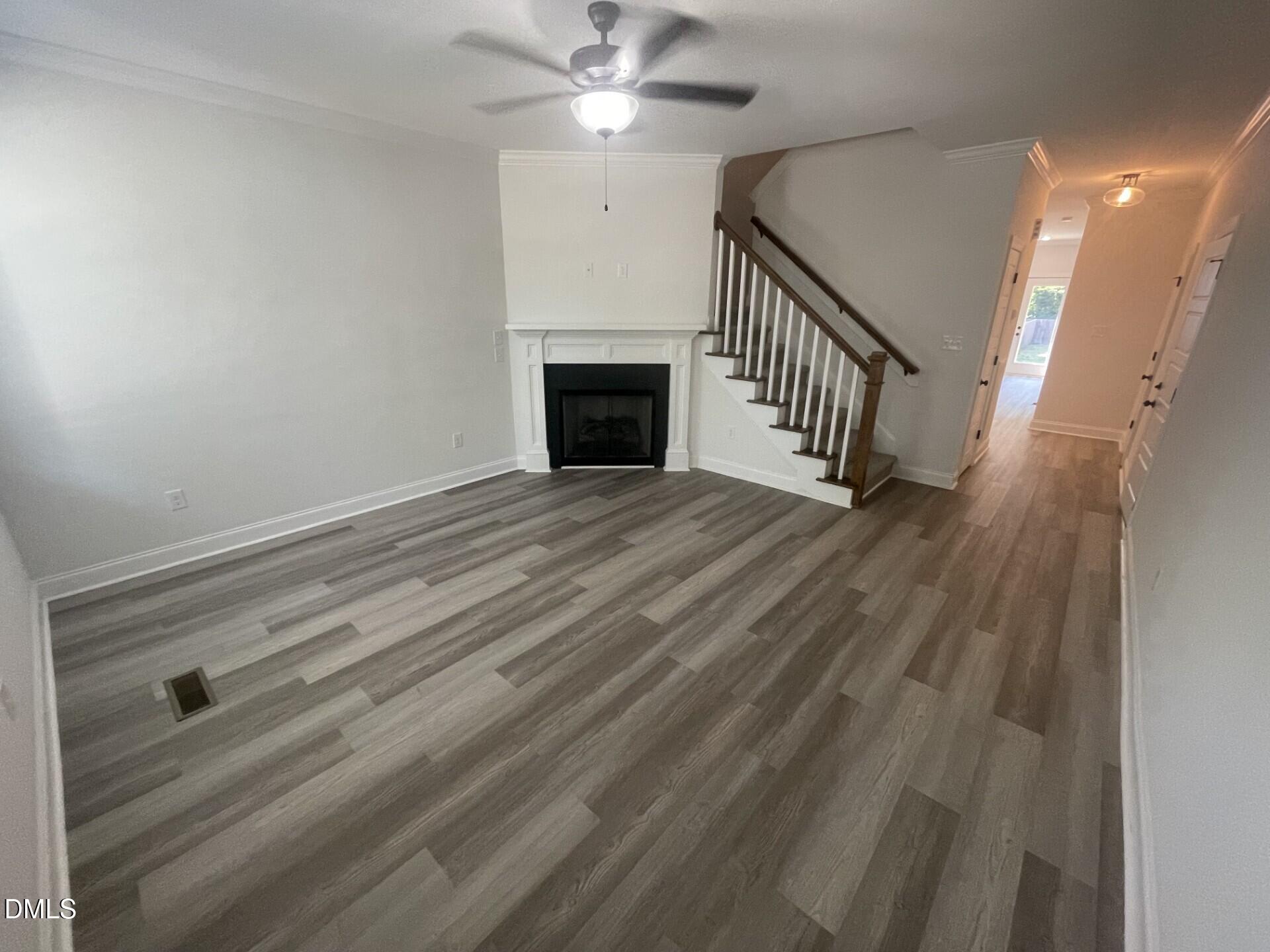 208 West Sycamore Street, Unit A Zebulon, NC 27597 - Photo 3 of 3 a view of empty room with wooden floor and fan