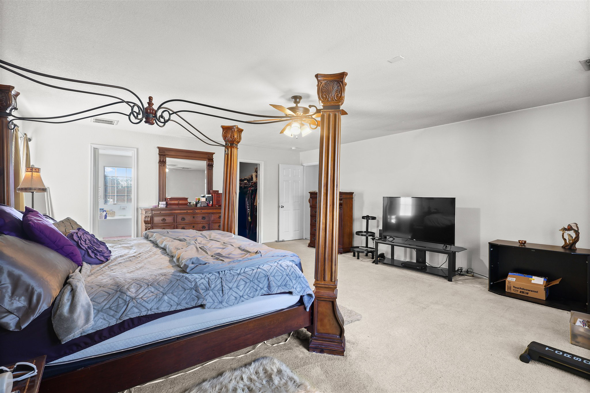 3743 Brighton Springs Lane Katy, TX 77449 - Photo 18 of 40 a bedroom with a bed and a flat tv screen on dresser