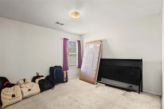 a view of room with closet and a ceiling fan