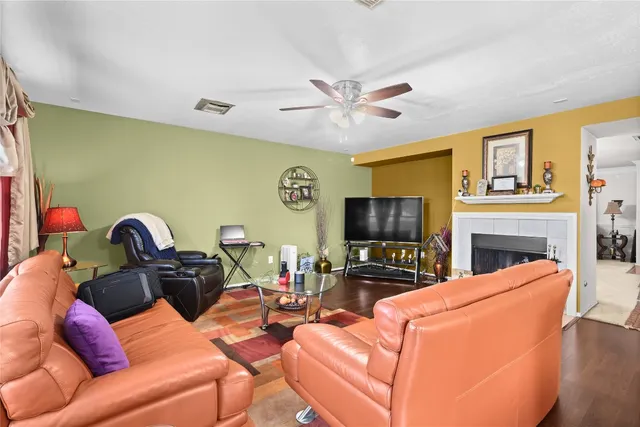 a living room with furniture a fireplace and a flat screen tv