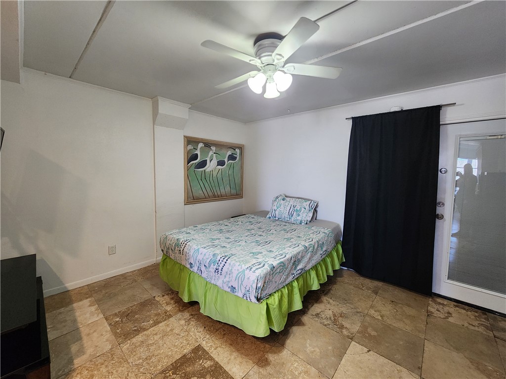 14300 South Padre Island Drive, Unit 16 Corpus Christi, TX 78418 - Photo 5 of 20 a bedroom with a bed and a chandelier