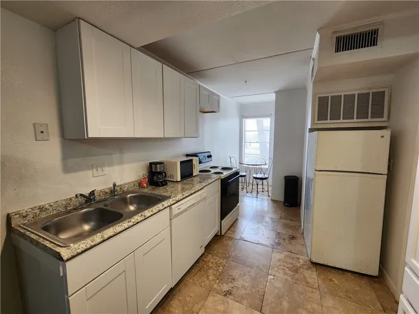 a kitchen with a sink a stove and refrigerator