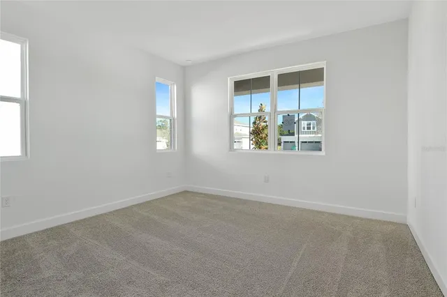 an empty room with windows and closet
