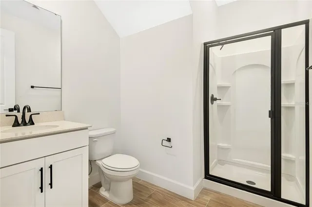 a bathroom with a toilet a sink and a mirror