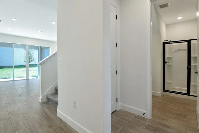 a view of hallway with wooden floor