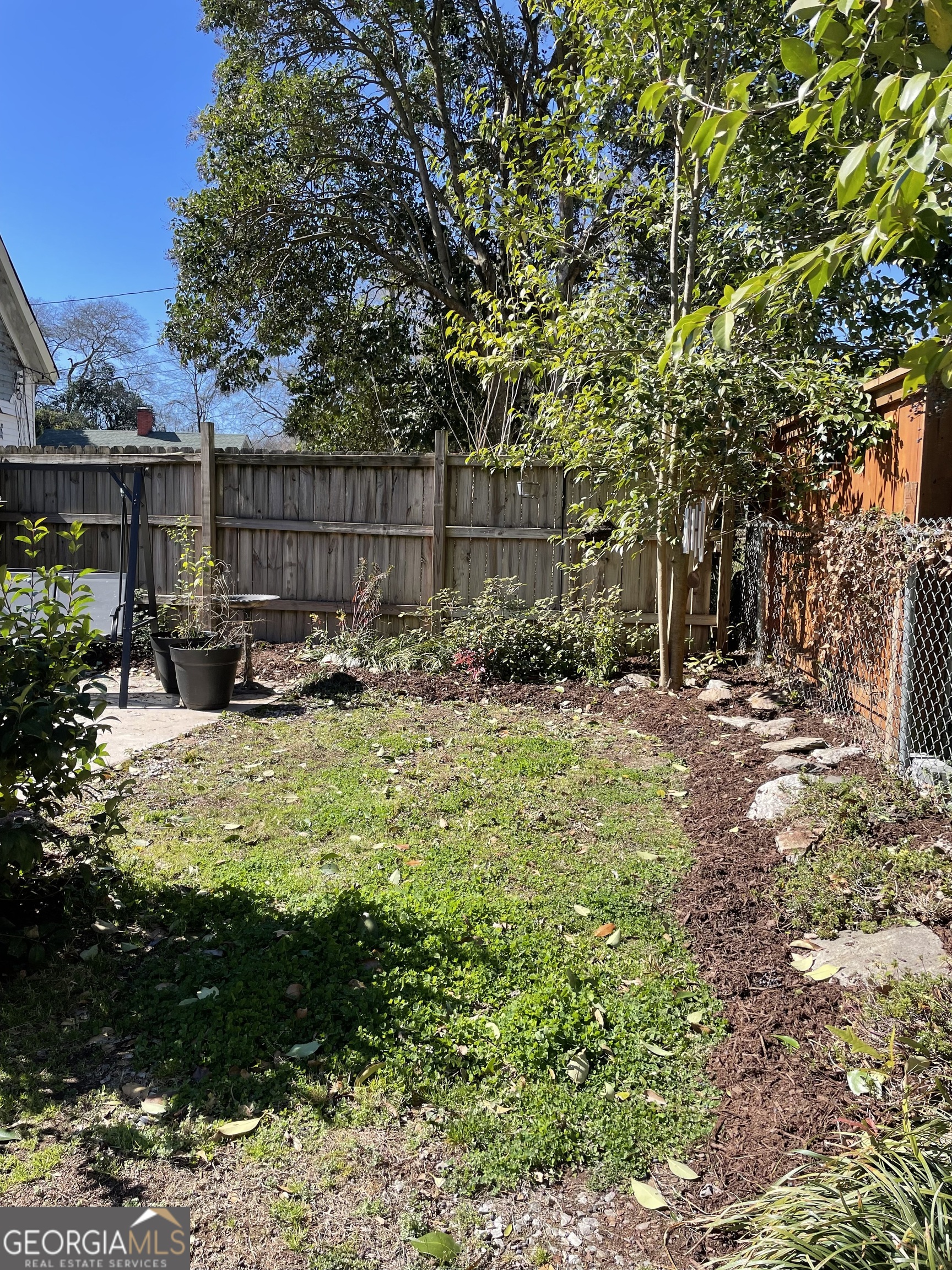 200 South Jackson Street Hartwell, GA 30643 - Photo 6 of 26 a view of a backyard with plants and large trees