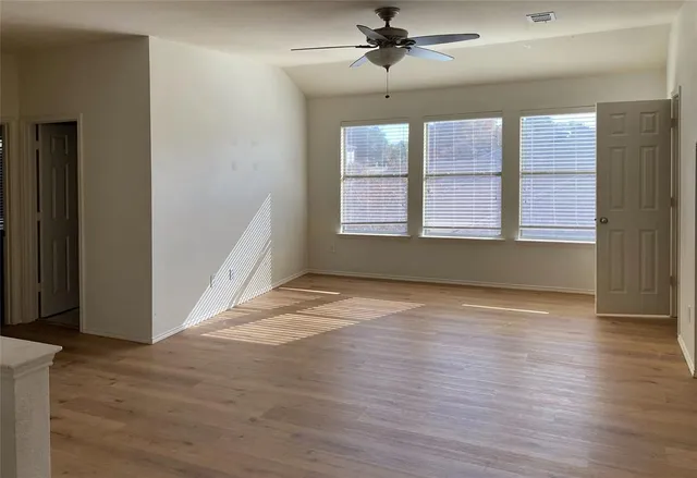 wooden floor in an empty room with a window