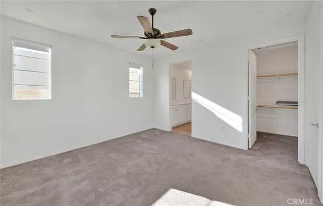 a view of a livingroom with a ceiling fan and window