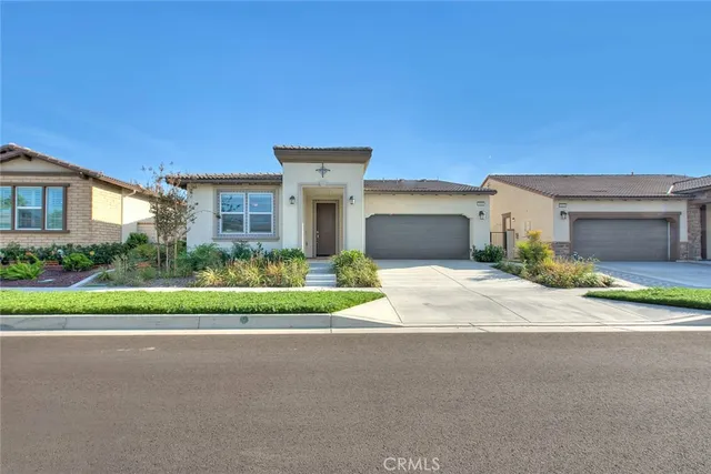 a front view of a house with a yard and a garage