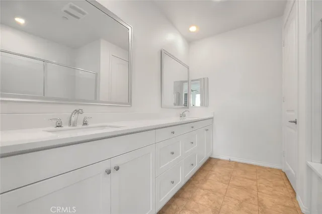 a bathroom with a sink a mirror and a shower