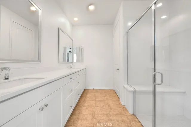 a bathroom with a shower and a glass door