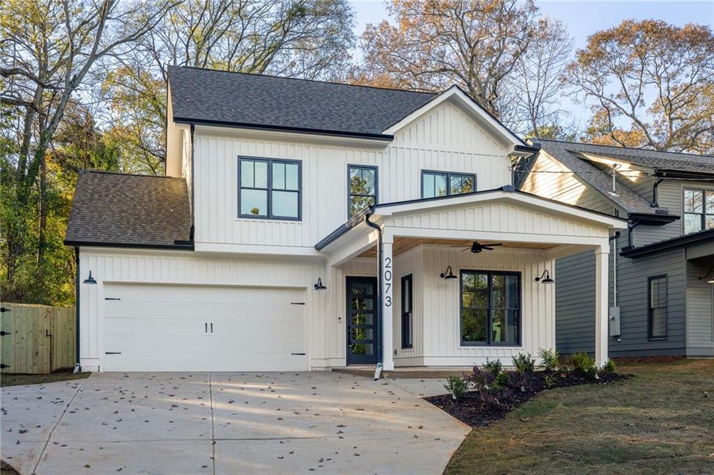 2073 Candler Road Southeast Atlanta, GA 30317 - Photo 1 of 1 a front view of a house with a yard and garage
