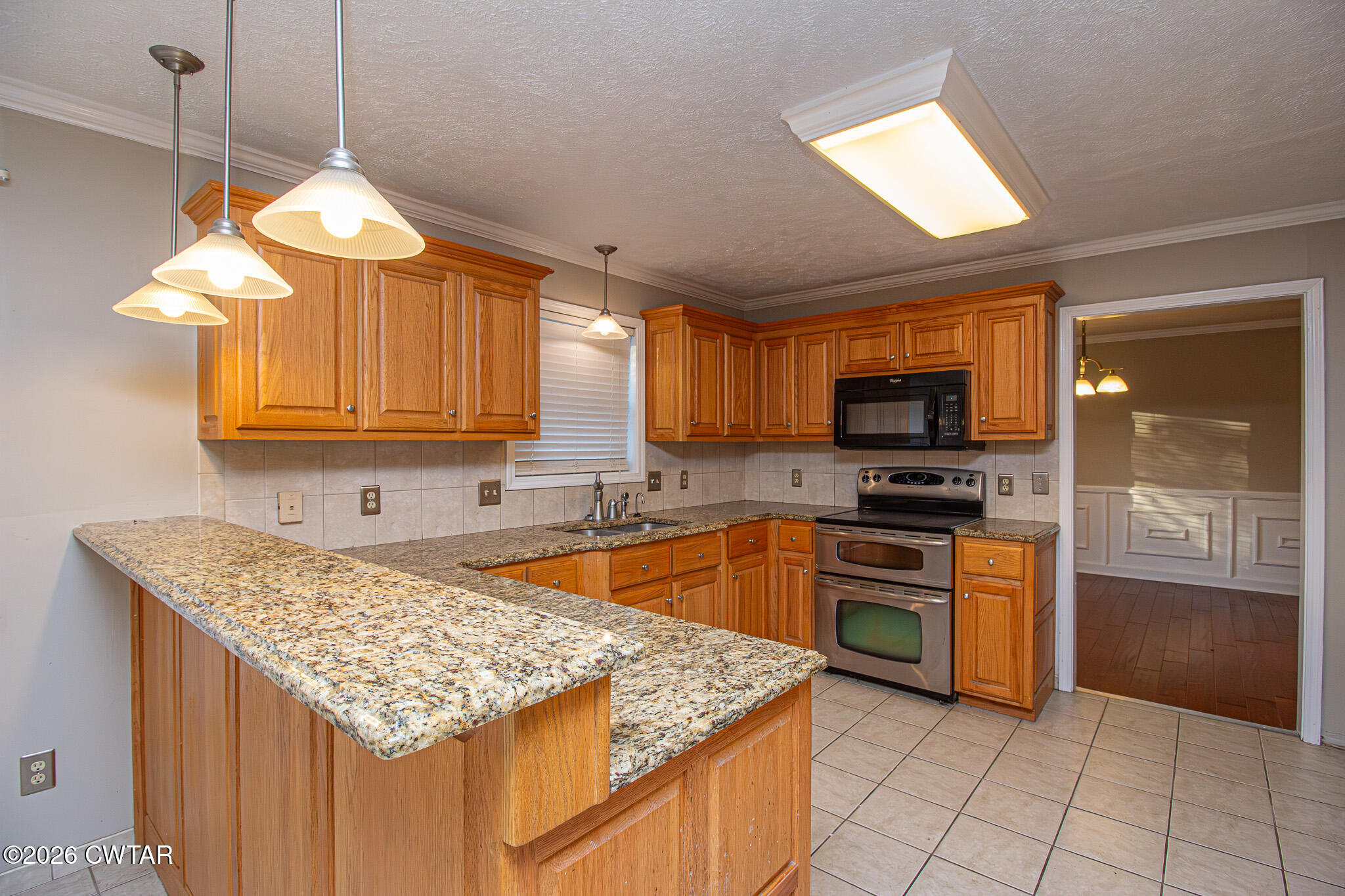 231 Tuckahoe Road Jackson, TN 38305 - Photo 11 of 39 a kitchen with stainless steel appliances granite countertop a sink stove and refrigerator