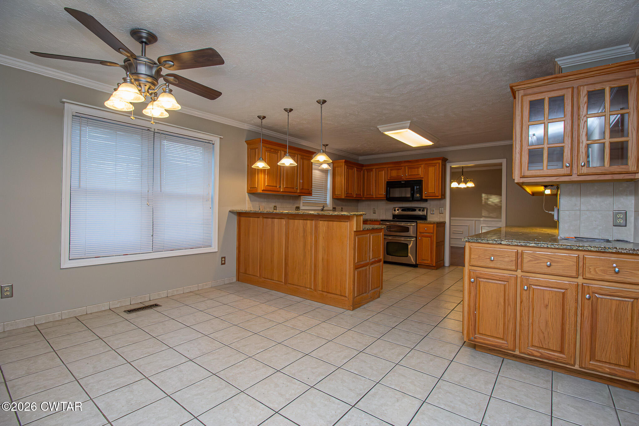 231 Tuckahoe Road Jackson, TN 38305 - Photo 16 of 39 a kitchen with stainless steel appliances kitchen island granite countertop a refrigerator and a sink