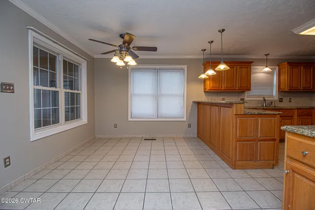 an empty room with windows and yard