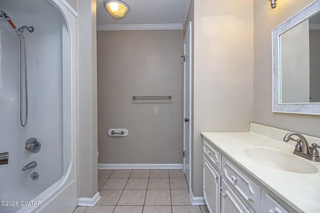 a view of a balcony with wooden floor and fence