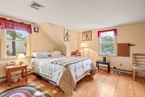 a view of living room with furniture and wooden floor