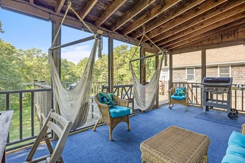 a view of house with deck and outdoor seating