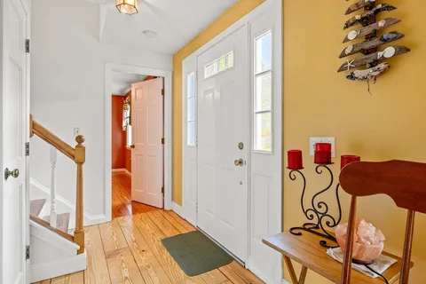 a view of an entryway with a door and wooden floor
