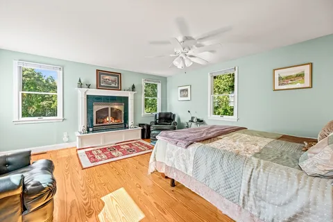 a bedroom with a bed and a fireplace