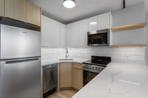 a kitchen with a sink stainless steel appliances and cabinets
