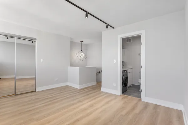 a view of a room with wooden floor cabinet and closet
