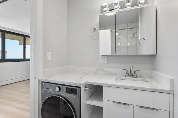 a utility room with cabinets washer and dryer