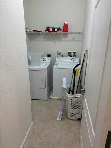 a utility room with sink dryer and washer