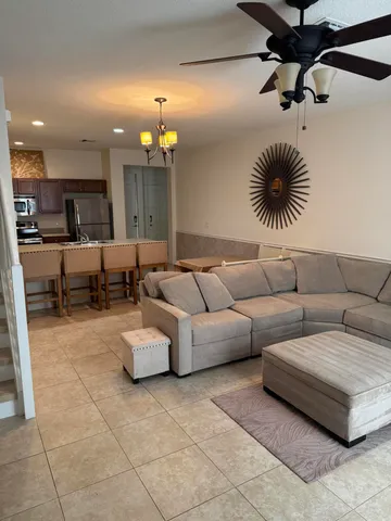 a living room with furniture and a chandelier