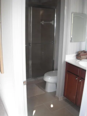 a white toilet sitting next to a bathroom sink