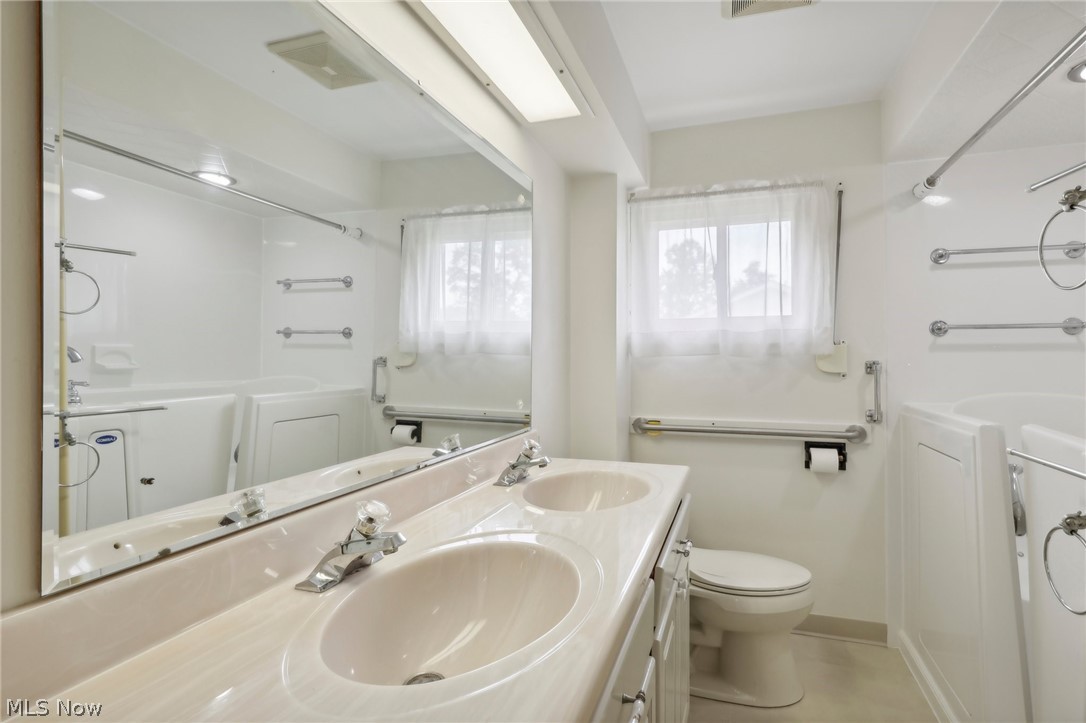 3873 Baumberger Road Stow, OH 44224 - Photo 18 of 50 Bathroom with tile flooring, dual sinks, toilet, and large vanity
