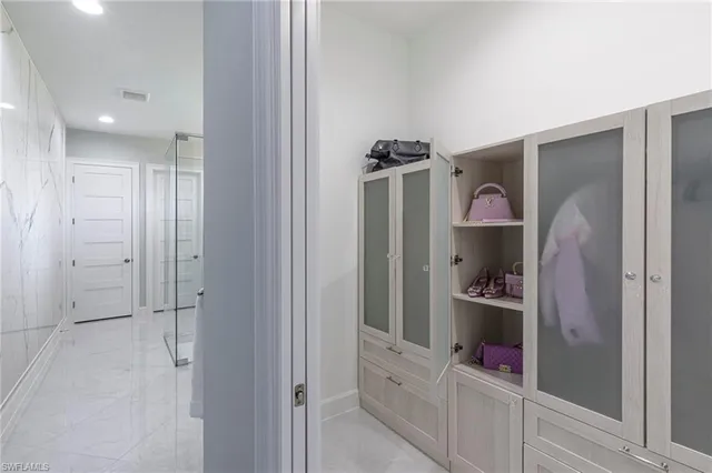 a bathroom with a double vanity sink mirror and shower