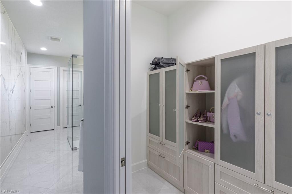 8963 Gustavia Court Naples, FL 34113 - Photo 13 of 47 a room with wooden floor and closet