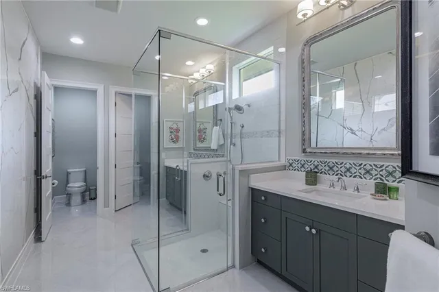 a bathroom with a shower sink double and mirror