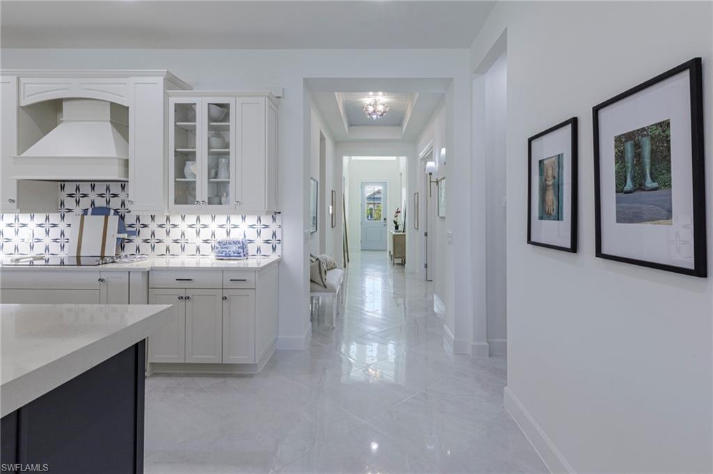 8963 Gustavia Court Naples, FL 34113 - Photo 17 of 47 a bathroom with a sink and mirror