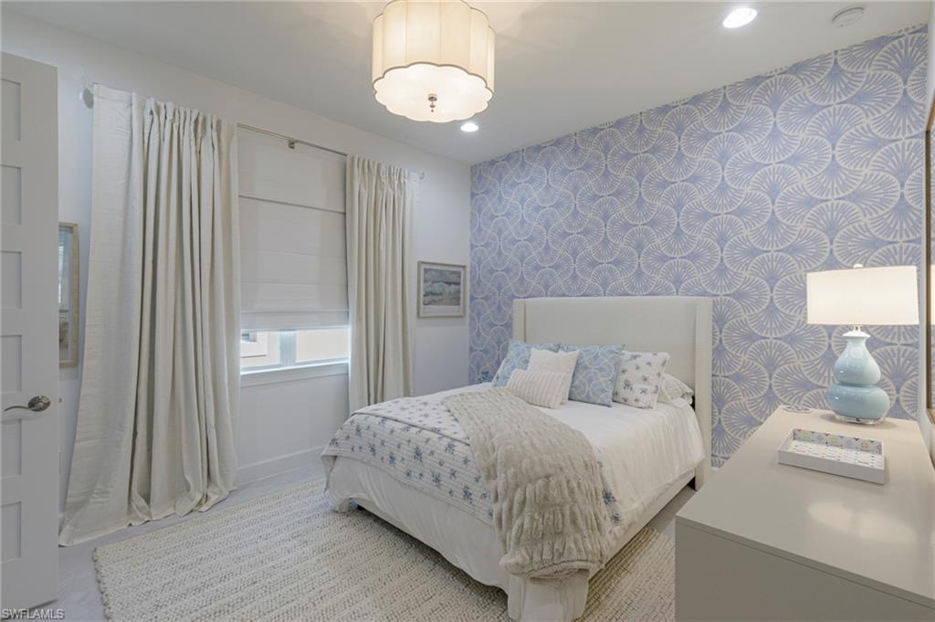 8963 Gustavia Court Naples, FL 34113 - Photo 19 of 47 a bedroom with a bed and a window