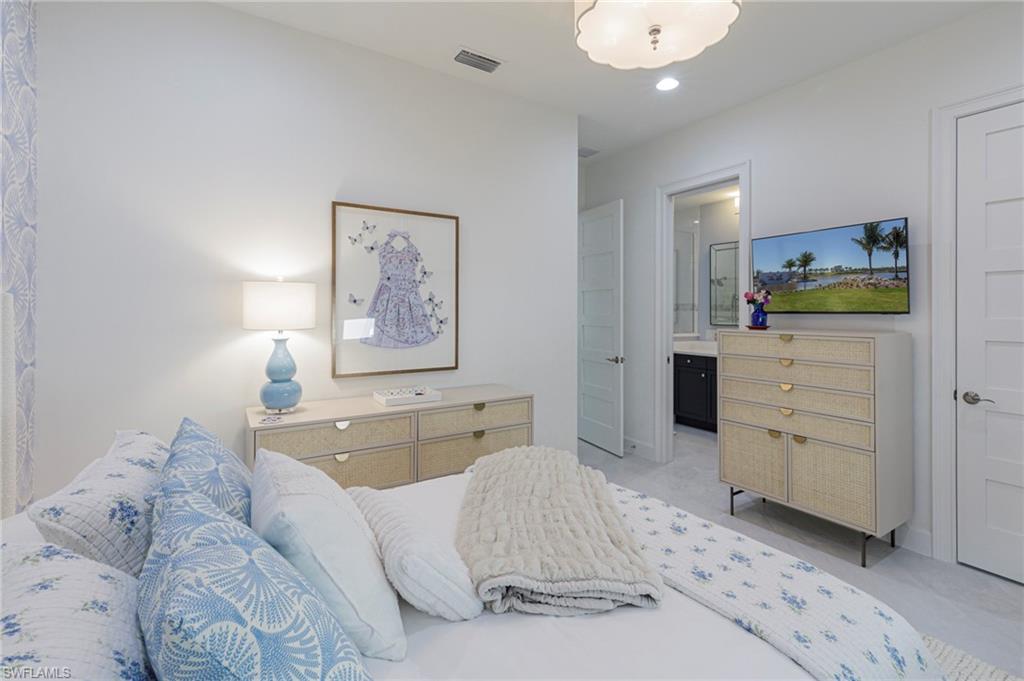 8963 Gustavia Court Naples, FL 34113 - Photo 21 of 47 a bed room with a bed and furniture