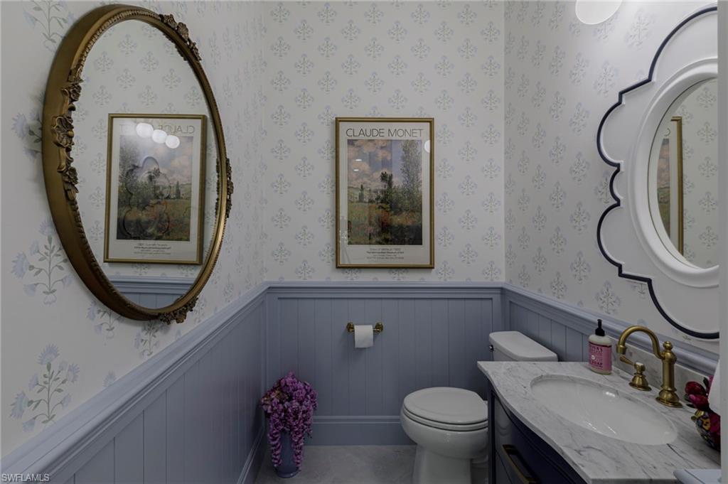 8963 Gustavia Court Naples, FL 34113 - Photo 30 of 47 a bathroom with a toilet a sink and a mirror