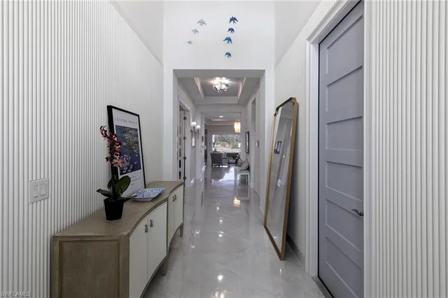 a large kitchen with a counter space dining table and a chandelier