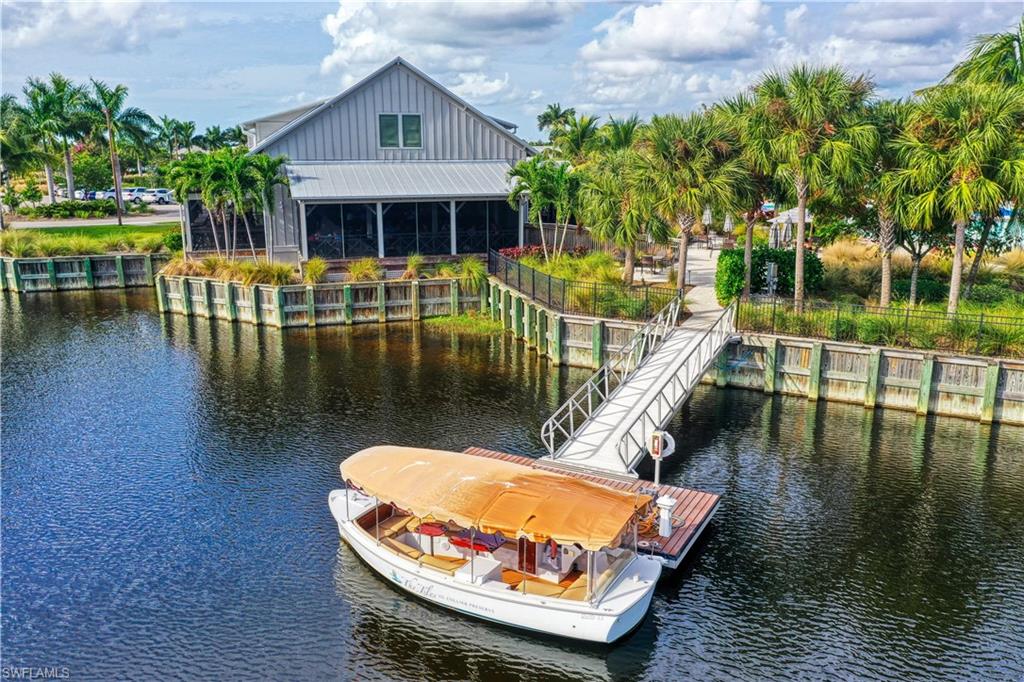 8963 Gustavia Court Naples, FL 34113 - Photo 39 of 47 swimming pool with outdoor seating and yard