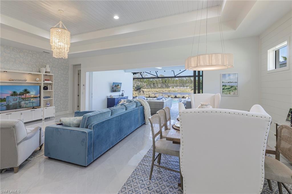 8963 Gustavia Court Naples, FL 34113 - Photo 5 of 47 a living room with furniture and a large window