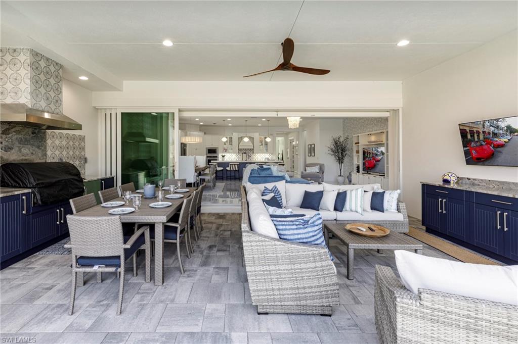 8963 Gustavia Court Naples, FL 34113 - Photo 8 of 47 a living room with furniture and a fireplace