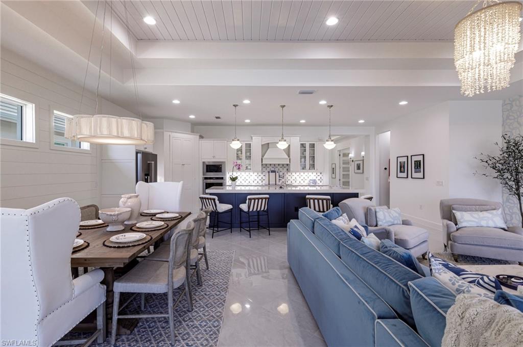 8963 Gustavia Court Naples, FL 34113 - Photo 9 of 47 a large kitchen with a table and chairs