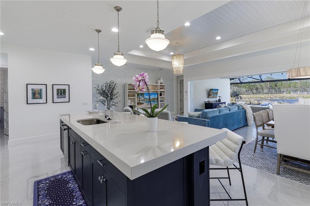 8963 Gustavia Court Naples, FL 34113 - Photo 10 of 47 a kitchen with a table and chairs in it