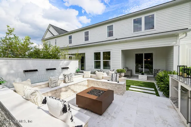 a view of a patio with couches chairs and a fire pit