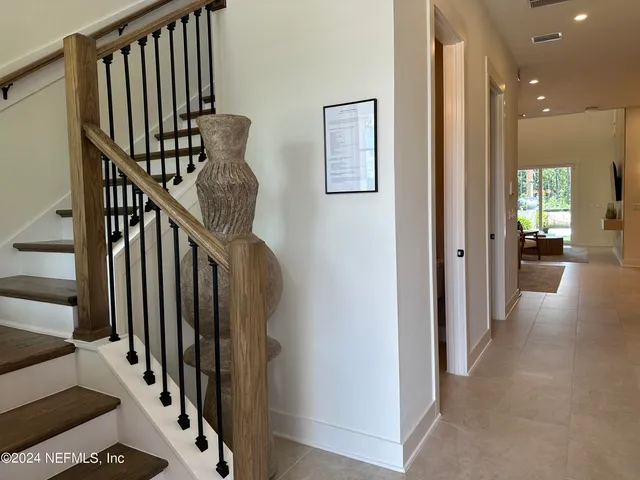 a kitchen with stainless steel appliances granite countertop a sink a stove a refrigerator and island with wooden floor