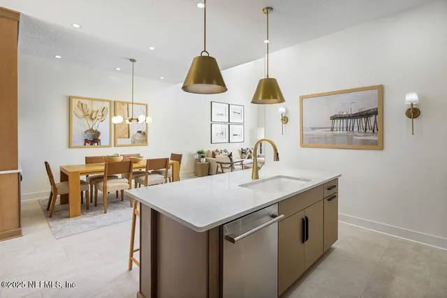a kitchen with stainless steel appliances a sink dishwasher and cabinets