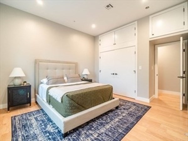 243 Condor Street, Unit 3 Boston, MA 02128 - Photo 11 of 16 a bedroom with a bed and wooden floor
