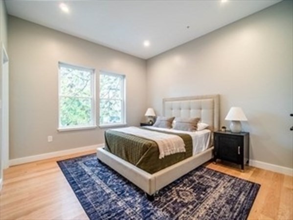 243 Condor Street, Unit 3 Boston, MA 02128 - Photo 12 of 16 a bedroom with a bed and wooden floor